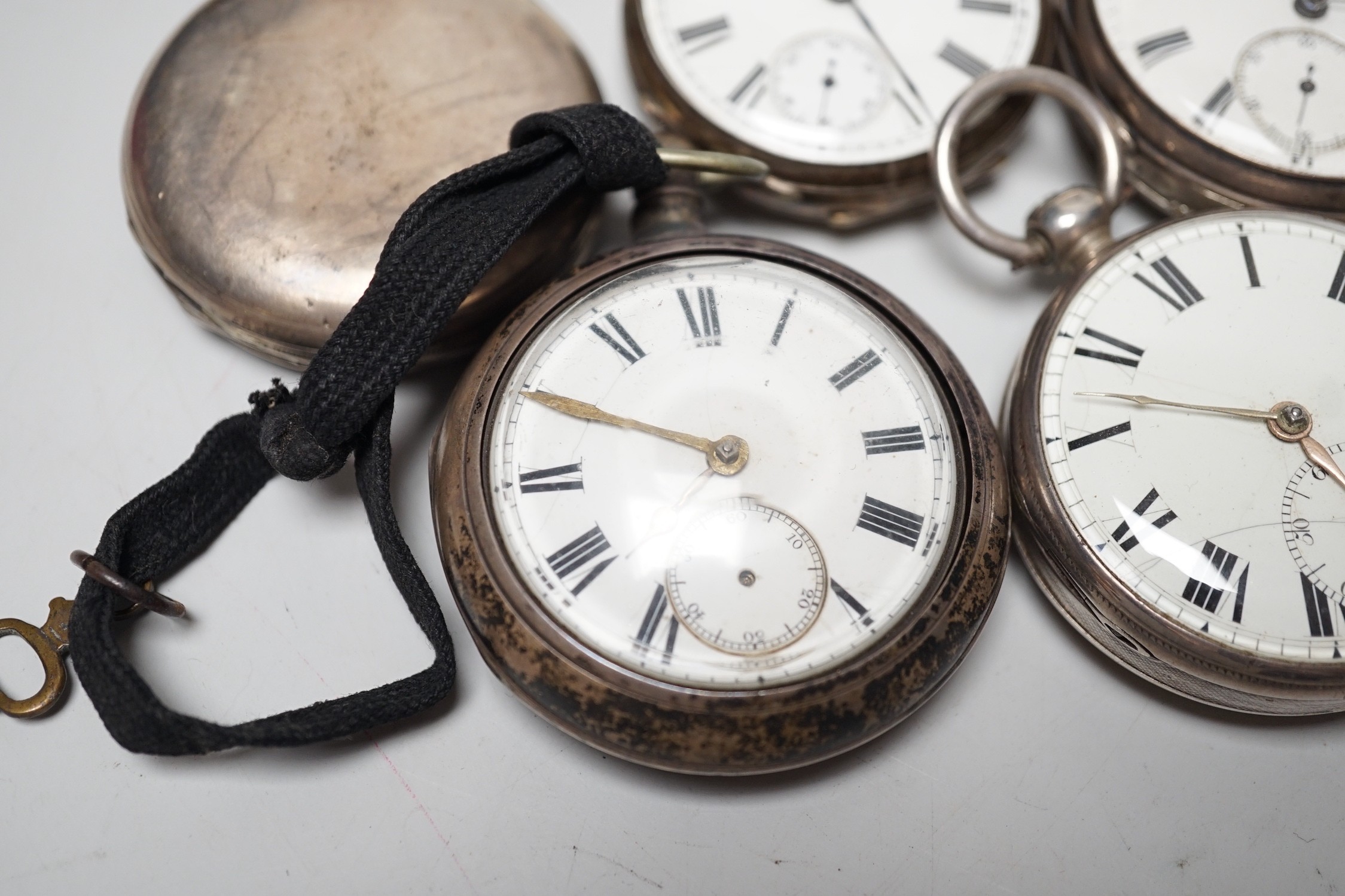 A 19th century silver pair cased keywind verge pocket watch, unsigned movement, together with three silver open faced keywind pocket watches including Fearn, Cornhill and a silver hunter pocket watch by Tanner of Lewes.
